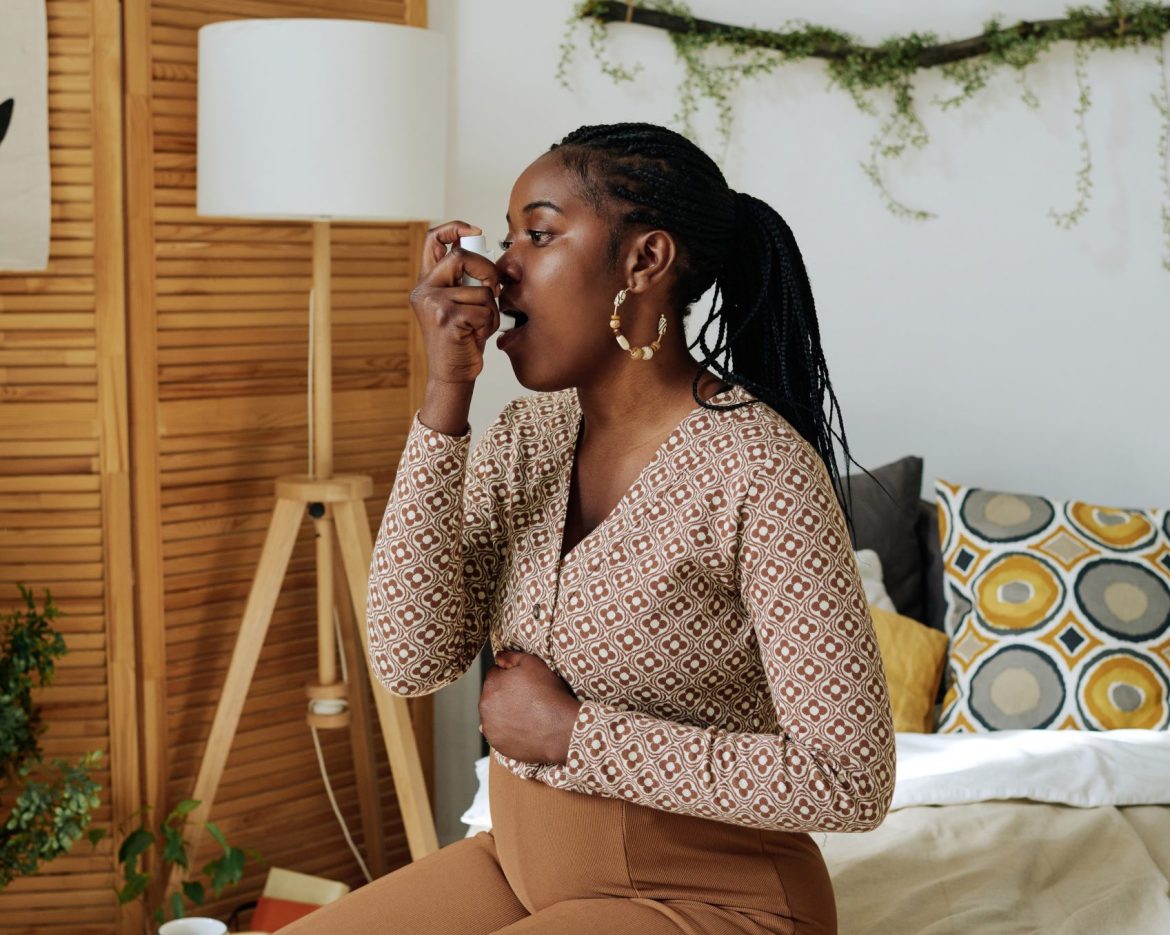 Pregnant woman doing inhalation at home