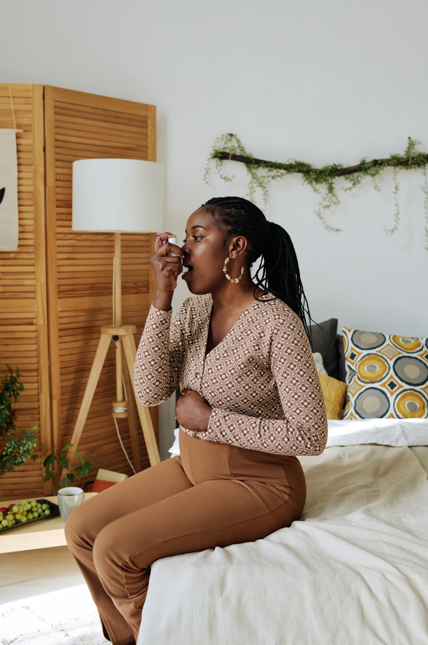 Pregnant woman doing inhalation at home