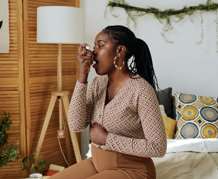 Pregnant woman doing inhalation at home