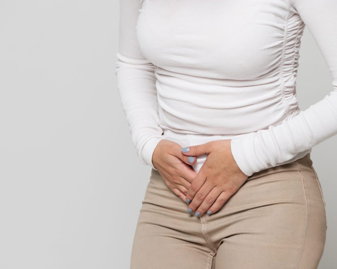 Woman suffering from stomach pain, feeling abdominal pain or cra