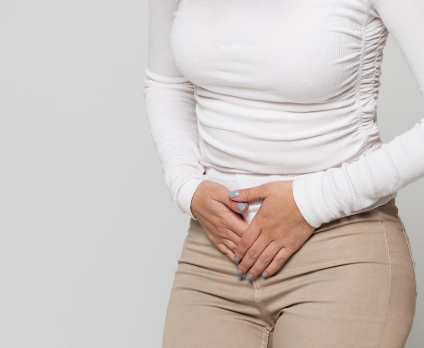 Woman suffering from stomach pain, feeling abdominal pain or cra
